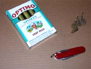 Ingredients for rolling a first-class blunt with marijuana, knife and Optimo Sports blunts.