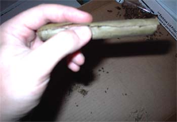 Rolling a blunt, taking care so that the lower flap of the blunt contains a core of compress marijuana and the top flap is free to seal the blunt later.