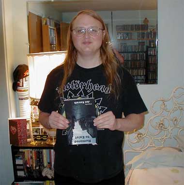 ray miller of metal curse magazine and death metal band adversary holding up jon konrath's book rumored to exist