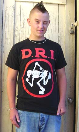 Thrash bands had awesome tshirts like the late-model DRI shirt this kid is wearing