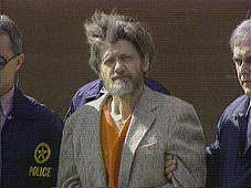 Unabomber suspect Theodore 'Ted' Kaczynski being led to a legal proceeding.